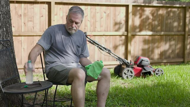 dehydrated senior man sitting suffering from heat stroke