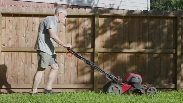 dehydrated senior man cutting grass showing signs of heat stroke