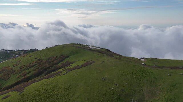Drone Aerial of Green Hills and Mountain Cabins Near Gomismta with Clouds Rolling In