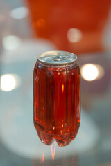 Unique display of a can with vibrant red beverage in a modern setting