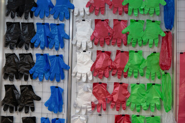 Colorful variety of disposable gloves displayed at a retail store