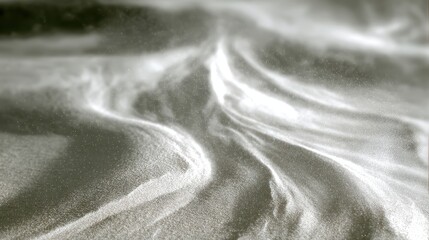 Wind-blown sand swirl patterns on softly blurred dune field