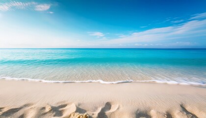 minimalistic beach background featuring white sand in sharp focus with a blurred turquoise ocean and sky in the distance the soft bokeh effect creates a dreamy calm atmosphere ideal for summer theme