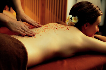 Couple customer having exfoliation treatment in luxury spa salon with warmth candle light ambient....