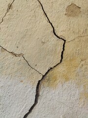 Cracked beige stone texture with prominent fracture for geology websites, construction materials catalogs and natural surface patterns