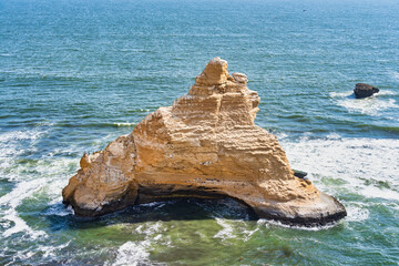 Sharp rock formation on the coast of Pacific Ocean at Paracas National Reserve, Peru