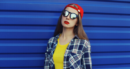 Stylish young woman in colorful clothes, modern teenage girl posing on city street