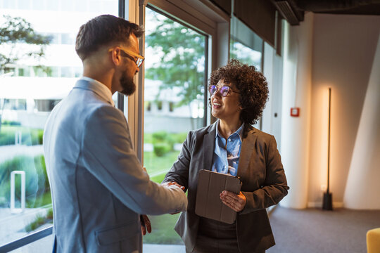 African american businesswoman handshake with caucasian man colleague