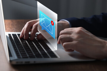 Email marketing, new message notification. Man using laptop at table, closeup