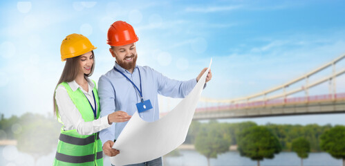 Construction engineers with draft against bridge outdoors. Banner design