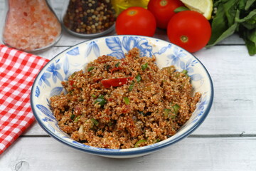 Traditional Turkish bulgur salad Kisir close-up on a plate on the table. Horizontal view from above