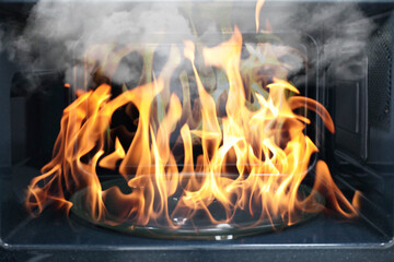 Fire and smoke in microwave oven, closeup