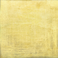 Fototapeta premium Vintage yellow textured background with distressed brush marks and subtle grunge effect, warm aged surface ideal for scrapbooking, posters, invitations, and graphic design projects.