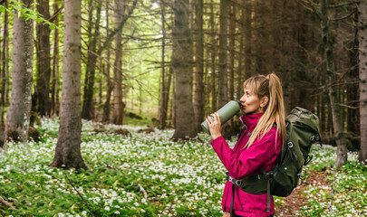 Woman Walking through Blooming Forest Glade
