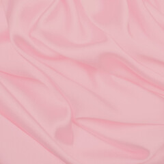Soft pink silky fabric texture with smooth flowing folds and elegant drapery, ideal for feminine designs, beauty branding, invitations, backgrounds, and romantic graphic projects.