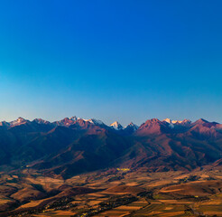 Majestic mountain range with snow-capped peaks at twilight