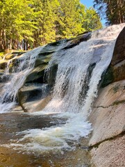 Mumlava Waterfall in Czechia, powerful cascade in forested mountains