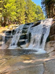 Mumlava Waterfall in Czechia, powerful cascade in forested mountains