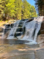 Mumlava Waterfall in Czechia, powerful cascade in forested mountains