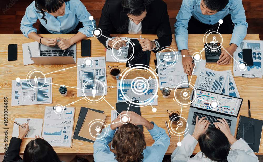 Aufkleber a diverse business team engages in a dynamic collaboration around a table, using laptops and documen