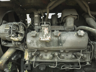 The mighty engine of an industrial vehicle, abandoned to its fate, is now a mass of metal consumed by rust