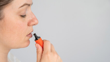 Caucasian woman smoking disposable vape. 