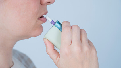 Caucasian woman smoking electronic cigarette. Tobacco heating system.