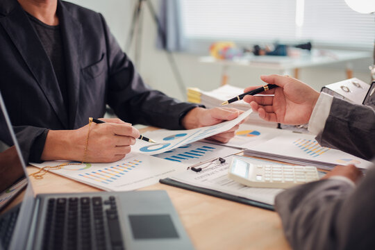 Business team discuss and explain marketing plan to plan financial strategy for business owner using laptop, calculator, chart sheet to calculate and summarize results. Business and finance concept.