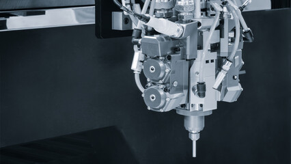 Industrial machine makes three metal rings. Metalworking industrial concept background blue tone