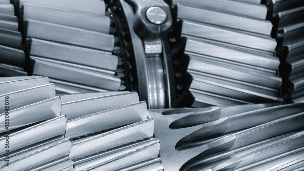 Poster Close up of a gear, gears are all different sizes and shapes, and they are all lined up next to each other. Concept of precision complexity blue tone