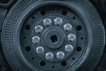 close up of tire with many small round holes. is dark blue and shiny. holes are evenly spaced and...