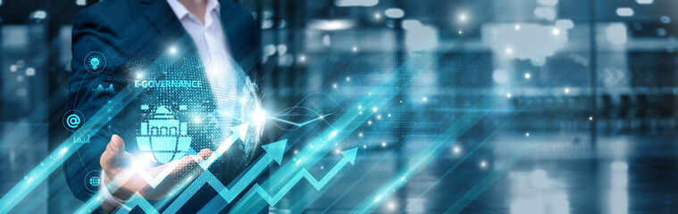 Businessman holding e-governance icon and digital transformation global network, transparent...