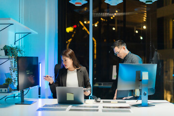 Asian Professionals Working Late in Modern Office