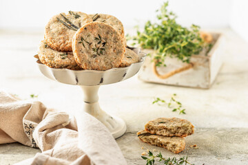 Shortbread cheese cookies with aromatic herbs on rustic textured background. Savory parmesan cookies for party