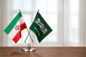 Iran and saudi arabia flag close on a table.