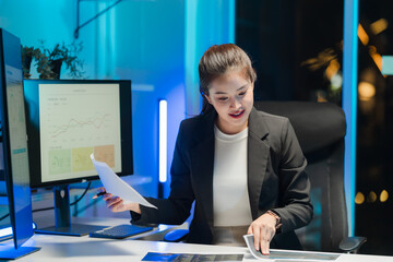 Asian Businesswoman Analyzing Data at Night