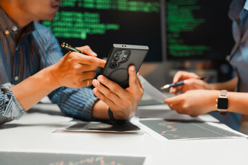 Business Team Analyzing Data on Smartphone