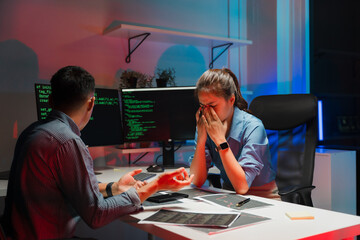 Stressed Woman Working with Colleague on Computer Code