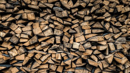 Stacked wood logs ready for winter season at a rural location in the countryside