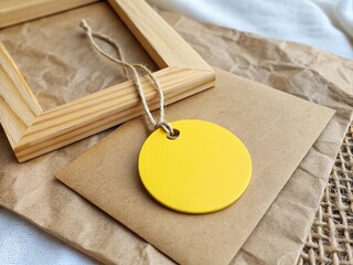 Yellow Round Tag Mockup on Kraft Paper with Wooden Square – Minimal Branding Scene.