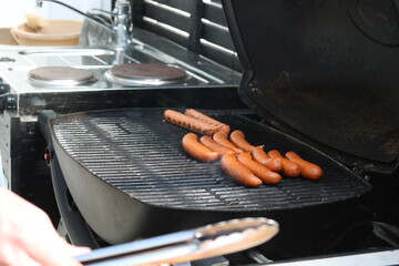 Grilling Sausages on Outdoor Barbecue Grill
