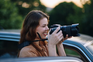 Young female photographer capturing nature with her camera, showcasing a joyful expression and...