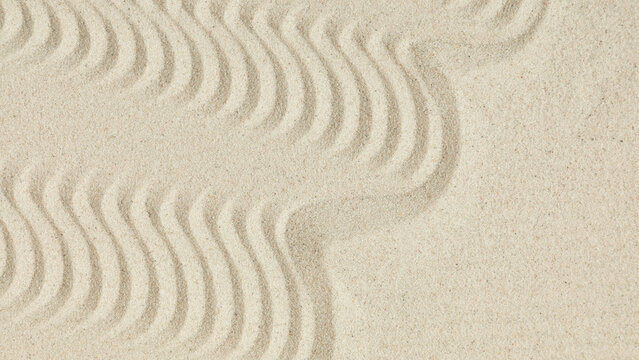 White clean sand with wave pattern as background.