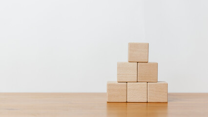 Empty wooden blocks and stack up in white background. Arranging of cube shape toy blocks in business concept on building, progress or development.