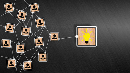 Fototapeta premium Teamwork and creative idea development. Brainstorming. Creative collaboration in business. Team members connect with idea light bulb symbol on wooden cubes.