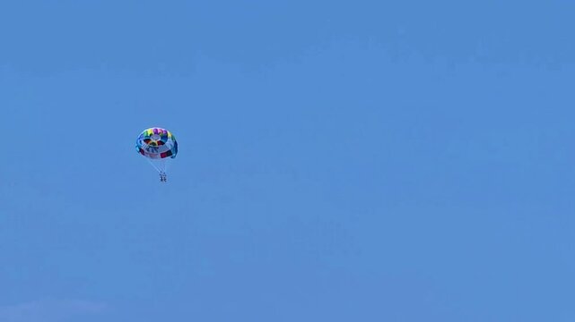 Parasailing in the sea. A popular tourist pastime with a parasailing parachute attached to a motorboat. 