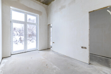 The room is under construction with a rough finish, plastered walls, concrete floor. Living Room Bedroom Area