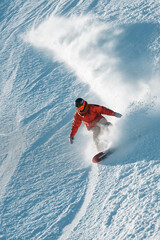 Very fast snowboarder slides at ski slope