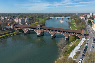 Aerial view of Ponte Coperto (Covered Bridge) crossing Ticino River. It's a famous tourist landmark of Pavia, Italy