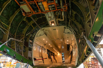 Open cargo cabin of transport aircraft in aviation hangar